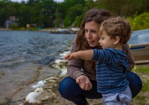 Abigail Bodner, a Ph.D student at Brown University, observes surface waves in Plymouth, Massachusetts with her son Micah. (Photo by Eyal Guzi)
