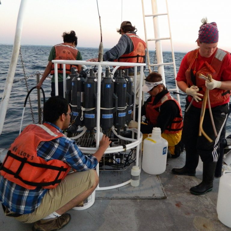 McDonald_Cruise2 Onboard the R/V Bellows, researchers collect water samples taken at various depths from the CTC rosette for microscopic identification, nutrient chemistry, DNA extraction for microbial community structure of prokaryotes and eukaryotes, and for primary and bacteria production rates. From L-R: Mohammed Aljahdali (FSU student), Arjun Adhikari (Valdosta State student), Jim Nienow (PI at Valdosta State), Alexander Ren and Lois O’Boyle (UWF students). (Photo by Richard Snyder / UWF)