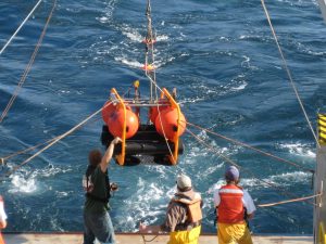 Development engineers at the Scripps Institute of Oceanography (SIO) deploy a High-frequency Acoustic Recording Package (HARP) from the R/V Sproul. (Credit: SIO)