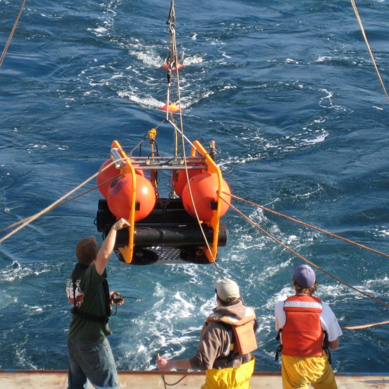 Development engineers at the Scripps Institute of Oceanography (SIO) deploy a High-frequency Acoustic Recording Package (HARP) from the R/V Sproul. (Credit: SIO)