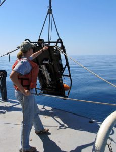 Karen Dreger (USF) deploys a Shadow Image Particle Profiling Evaluation Recorder (SIPPER) off the stern of the R/V Bellows for zooplankton assessment. (Credit: Carl Taylor (USGS)