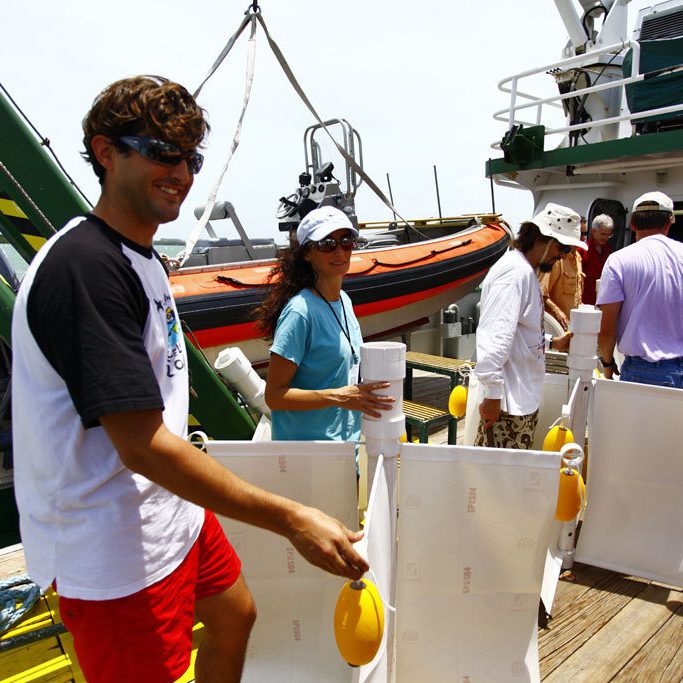 The CARTHE research team will deploy 300 custom-made drifters, as shown in this trial run, from the R/V Walton Smith. Left to Right: Dr. Guillaume Novelli, Dr. Angelique Haza, and Ph.D. student Matt Gough. Credit: Tamay Özgökmen (UM)