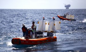 Researchers use small boats to deploy drifters at select locations. (Photo credit: Tamay Özgökmen, University of Miami)