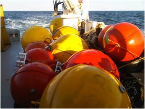A series of buoy and anchors to be used for mooring deployments during a physical oceanography cruise on the RV Pelican. Connected instruments on each line will record pressure, temperature, salinity and velocity. (Photo credit: Nico Wienders FSU)