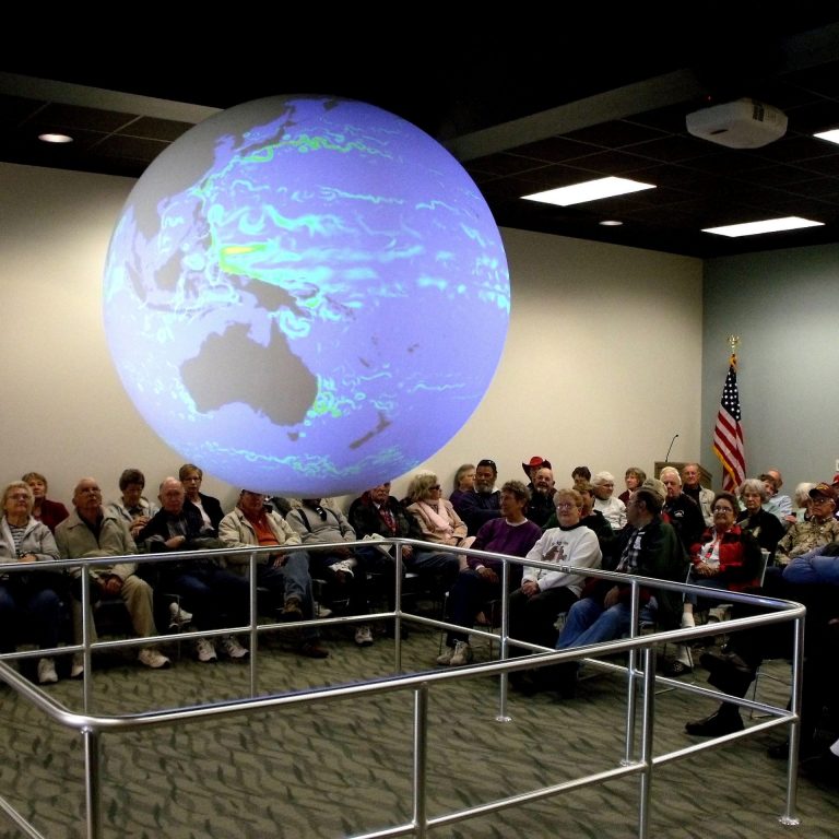 General public visitors attend a Science on a Sphere presentation at the Bay Education Center. (Photo by Jackie Hattenbach)