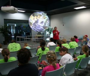 Children from Sea Camp attend a Science on a Sphere program at the Bay Education Center. (Photo by Carolyn Rose)