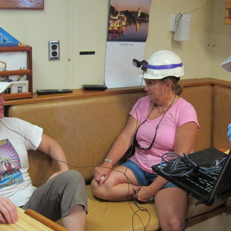 From the RV Weatherbird II, Dr. Jacqueline Dixon (left, Dean USF College of Marine Sciences) and teacher Patty Smukall Skype with students about connections between the oil spill and underwater volcanoes. Dr. Teresa Greely assists with the session. (Photo credit: C-IMAGE)