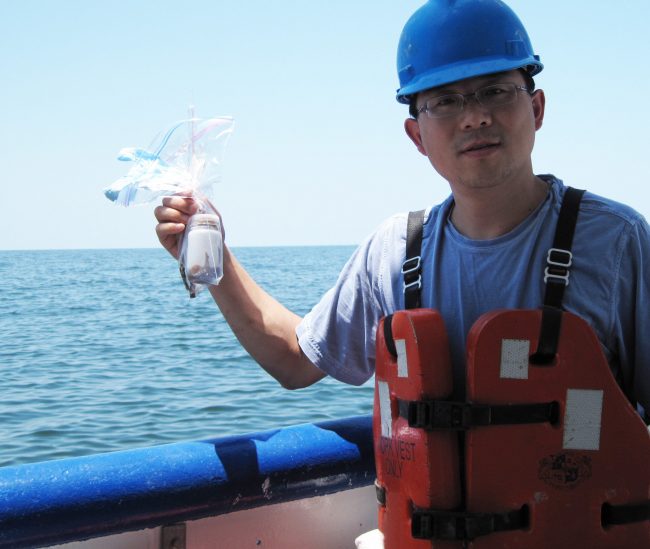 Liu_oilwatersample_IMG_1795 Dr. Zhanfei Liu (University of Texas at Austin) collected water samples in May 2010 in the northern Gulf of Mexico in areas affected by the Deepwater Horizon oil spill and used them to study the oil weathering process. (Photo credit: Z. Liu)