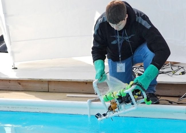 deploy rov Reed Dudley from Lake Weir High School (Ocala, FL) deploys his team’s ROV for the start of Mission I at the Deep-C Student ROV competition. (Photo credit: Tina Miller-Way)