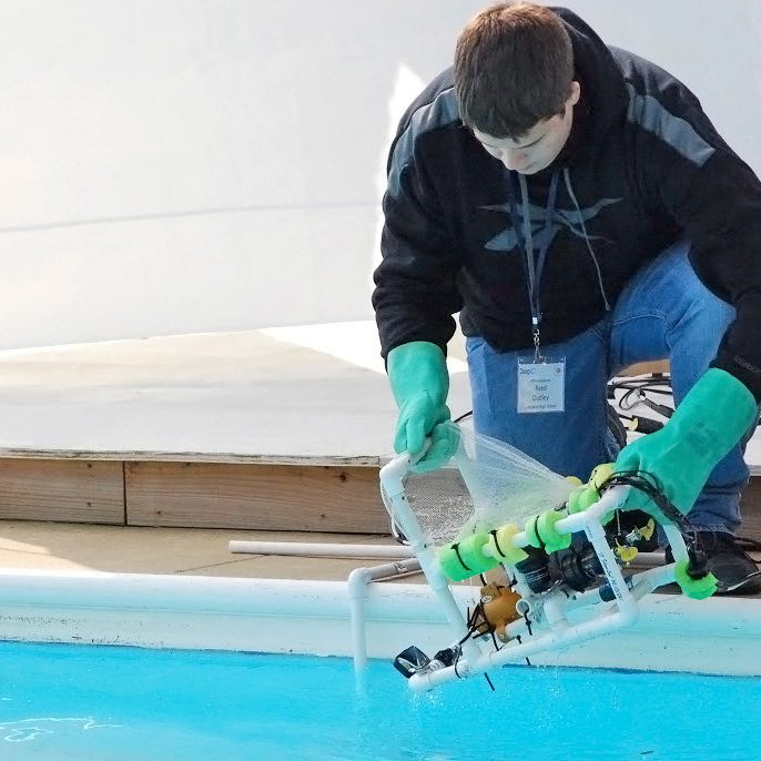 deploy rov Reed Dudley from Lake Weir High School (Ocala, FL) deploys his team’s ROV for the start of Mission I at the Deep-C Student ROV competition. (Photo credit: Tina Miller-Way)
