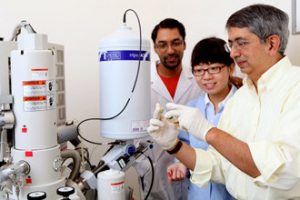Dr. Vijay John (R), Director of C-MEDS, reviews oil samples with graduate students Jingjian Tang and Pradeep Venkataraman using the cryo-scanning electron microscopy equipment in the Tulane Percival Stern laboratory to understand the role of dispersants in breaking up oil. (Photo by Sabree Hill)