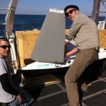The SailBuoy requires some assembly. Here, Kris Suchdeve and Dr. Nico Wienders attach the sail to the buoy’s hull. (Photo by Tracy Ippolito)