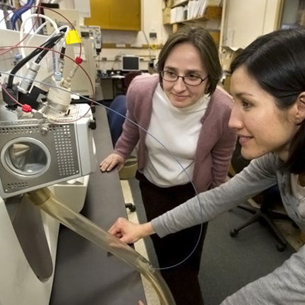 Dr. Liz Kujawinski (left) and a research associate at WHOI monitor a specialized mass spectrometer that measures the individual weights of compounds in a complex mixture to help identify those present. (Photo by Tom Kleindist, Woods Hole Oceanographic Institution)