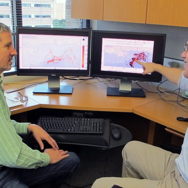 CARTHE_DietrichAndDawson Professor Clint Dawson and researcher Casey Dietrich discuss ways to improve the modeling of surface oil transport into the beaches of Mississippi and Louisiana. Dawson and Dietrich are members of the CARTHE. (Photo provided by Cas