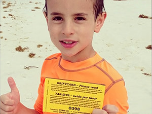 driftcard_gigem_boy-FEATURED A young boy found a driftcard while swimming at Santa Rosa beach, FL. His mother sent this message, “What a fun surprise since my husband and I are both former aggies….Our son loved it!!” (Photo courtesy of Amber C and GISR)