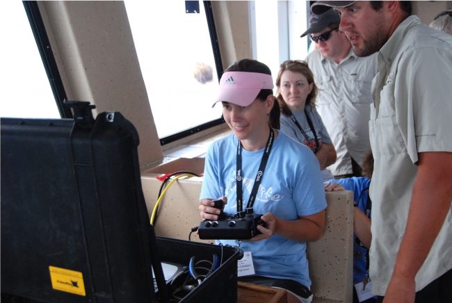 Deep-C_TeacherDrivingROV Fairview High School teacher Stephanie Chambers navigates an underwater ROV while out at sea aboard DISL’s R/V Alabama-Discovery. (Photo credit: Tina Miller-Way, DISL)