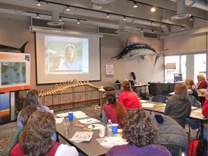 Dr. Teresa Greely (on screen) Skypes with educators during a professional development session at the New England Aquarium during IODP Expedition 340 in the Lesser Antilles. (Photo by: Jennifer Collins, Deep Earth Academy, COL)