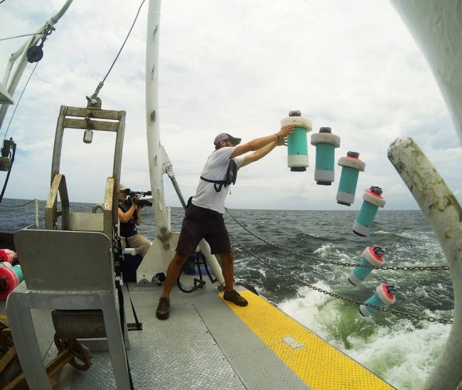 Conor Smith is shown here in a time lapse photo of one CARTHE drifter being deployed from the R/V Acadiana near the site of the Hercules rig. (Photo courtesy of CARTHE)