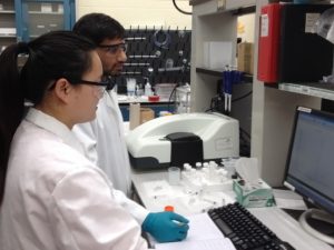 University of Rhode Island Chemical Engineering Ph.D. students Yuzi Zhang and Hari Katepalli measure zeta potentials of particles used to form oil-in-water emulsions. (Photo provided by Arijit Bose)