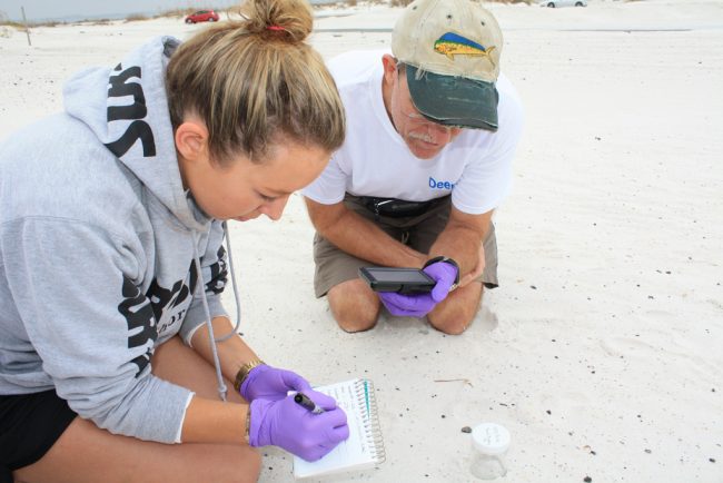 Catherine Carmichael, a research associate at WHOI, shows teacher Shawn Walker that taking detailed notes is essential when collecting data. (Photo by Danielle Groenen)