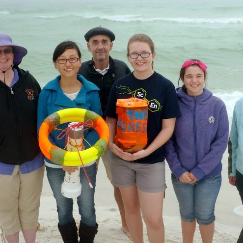 SCOPE_winning-drifter-designs The winning designs “Hannibal” and “The Aggressor” are field tested just prior to the experiment. Teacher Dana Fields (left) and her students from Rickards High School Environmental Systems class were able to accompany Dr. Nico Wienders (center) to the SCOPE deployment site at John Beasley Park in Okaloosa Island, FL. (Photo provided by Deep-C)