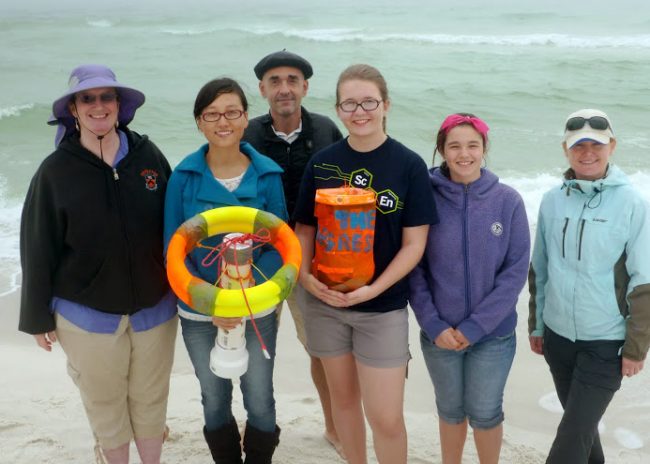 SCOPE_winning-drifter-designs The winning designs “Hannibal” and “The Aggressor” are field tested just prior to the experiment. Teacher Dana Fields (left) and her students from Rickards High School Environmental Systems class were able to accompany Dr. Nico Wienders (center) to the SCOPE deployment site at John Beasley Park in Okaloosa Island, FL. (Photo provided by Deep-C)