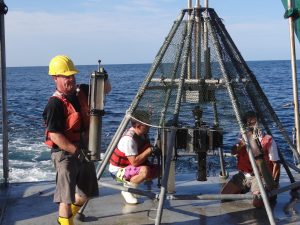 David Hollander (L), Patrick Schwing (C) and David Hastings (R) unload sediment cores sampled by the C-IMAGE Consortium near the Deepwater Horizon well site aboard the R/V Weatherbird II. Sediment cores have revealed a substantial quantity of the oil from DWH trapped in the deep sea. (Photo by Steven Murawski, University of South Florida and Director of C-IMAGE)
