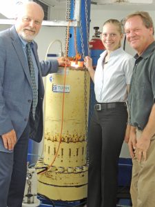 Scientists Steve Murawski and David Hollander flank Ph.D. student Karen Malone in front of the high-pressure/low temperature chamber that simulates wellhead conditions in the laboratory at TUHH in Hamburg. Malone won the Admiral James Watkins Award for Excellence in Research for Outstanding Student Poster at the 2014 Gulf of Mexico Oil Spill and Ecosystem Science Conference. (Photo by S. Gilbert)