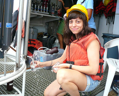 Alex Harper collects seawater samples from CTD Rosette Niskin bottles aboard R/V Weatherbird II. (Photo credit: Natalie Geyers)