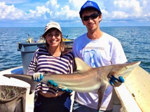 Alex Harper and Cheston Peterson, a Ph.D. Marine Biology student, show off an Atlantic sharpnose shark (Rhizoprionodon terraenovae) while conducting research as part of the NOAA Gulf Shark Pupping and Nursery (GulfSPAN) Survey. (Photo credit: Dean Grubbs)