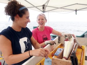 Susan Synder and Liz Herdter collect samples from a golden tilefish to measure PAH levels. (Photo credit: Steve Murawski)