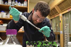 Andrew samples an oil-in-seawater emulsion, stabilized with polymer-coated iron oxide nanoparticles. (Photo provided by Worthen)