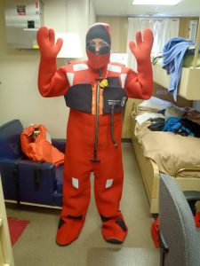 On NOAA's R/V Gordon Gunter, in the Gulf of Mexico, Kait Frasier dons a survival suit (referred to as a "Gumby Suit"). Researchers have to be able to get into it in under a minute, which takes some practice. (Photo provided by Frasier)