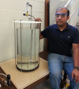 Amitesh Saha displays his setup to study the underwater injection of dispersant on an oil plume. (Provided by Saha)
