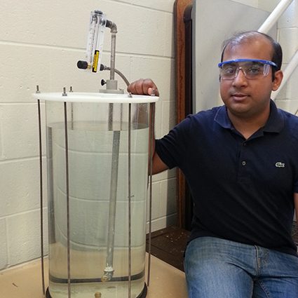 Amitesh Saha displays his setup to study the underwater injection of dispersant on an oil plume. (Provided by Saha)