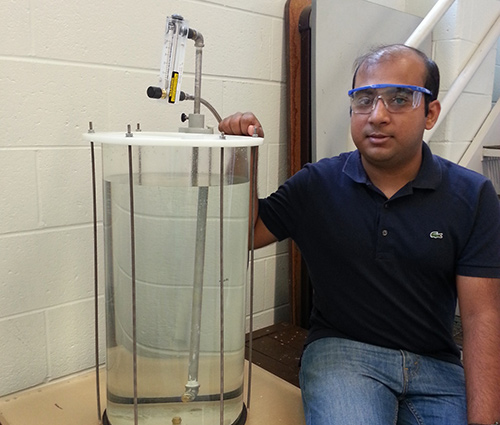 Amitesh Saha displays his setup to study the underwater injection of dispersant on an oil plume. (Provided by Saha)