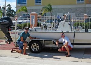 Dave Christiansen (left) and Garrett Kehoe (right) pose with their beloved but shambling boat trailer, which lost two of its four wheels during a data collection trip from Austin to Galveston Bay. (Photo credit: Matt Rayson)