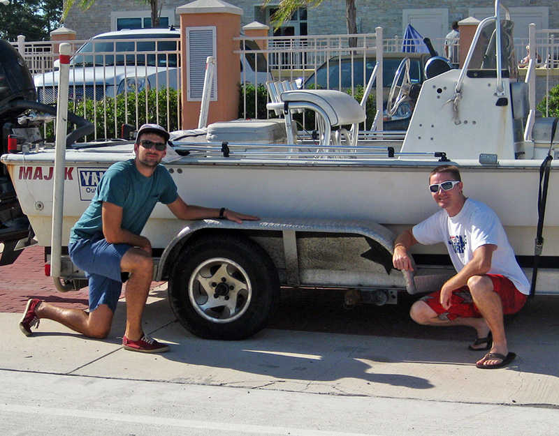 Dave Christiansen (left) and Garrett Kehoe (right) pose with their beloved but shambling boat trailer, which lost two of its four wheels during a data collection trip from Austin to Galveston Bay. (Photo credit: Matt Rayson)