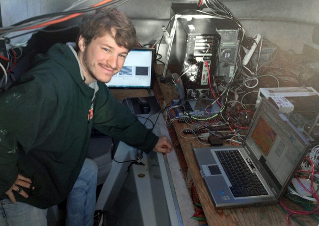 LaxagueCabin Nathan stands proudly in front of the data acquisitions system he set up inside the Surface Physics Experimental Catamaran (SPEC) during the 2013 Surfzone-Coastal Oil Pathways Experiment (SCOPE) in Destin, FL. (Photo credit: Tamay Özgökmen)