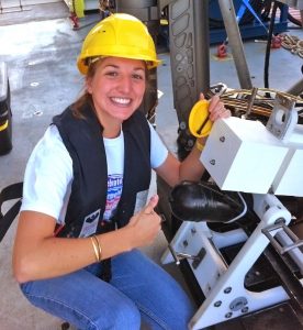Graduate student Caroline Johansen is happy to have the video time-lapse camera back on the R/V Falcor after a deep-sea deployment. She will analyze the data it collected near a natural seep. Image credit: Mauricio Silva with the Schmidt Ocean Institute.