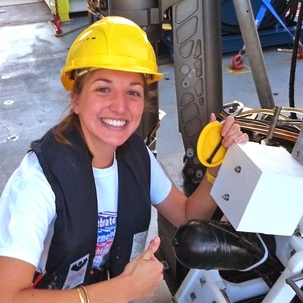 Graduate student Caroline Johansen is happy to have the video time-lapse camera back on the R/V Falcor after a deep-sea deployment. She will analyze the data it collected near a natural seep. Image credit: Mauricio Silva with the Schmidt Ocean Institute.