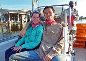 Xuan (right) and Brooke Hesson (left) en route to the marshes to collect insects and take soil samples. The boat’s captain, Jay Winters, can be seen in the background. (Photo provided by Xuan Chen)