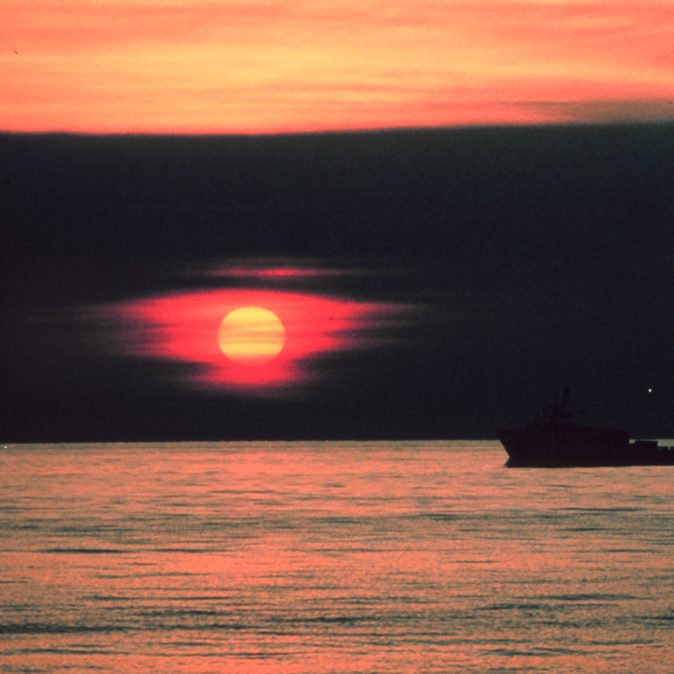 A gulf crew boat silhouetted in a Gulf of Mexico sunset. Offshore of Cameron, Louisiana. (Photo by: Commander Grady Tuell, NOAA Corps