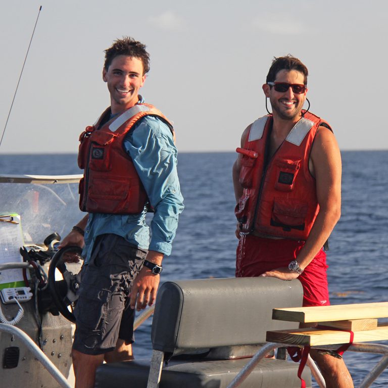 Conor and UM researcher Guillaume Novelli (right) celebrate the end of a long day recovering and redeploying drifters. On this day, they tracked one hundred drifters, recovered their GPS data, and released them back into the water. (Photo credit: David Nadeau)