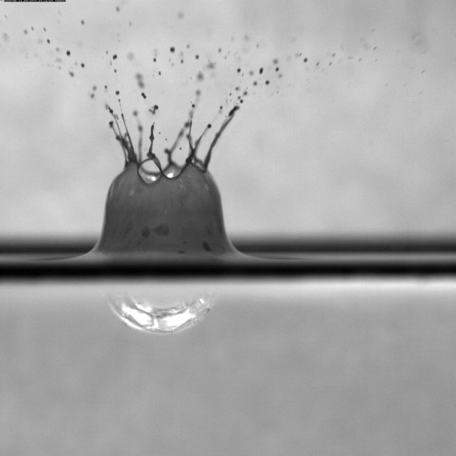 DROPPS_RainDropDispersed2 The DROPPS research consortium uses high-speed imagery to capture a rain drop as it falls into a surface oil slick treated with chemical dispersant. (Image credit to David Murphy, Johns Hopkins University)
