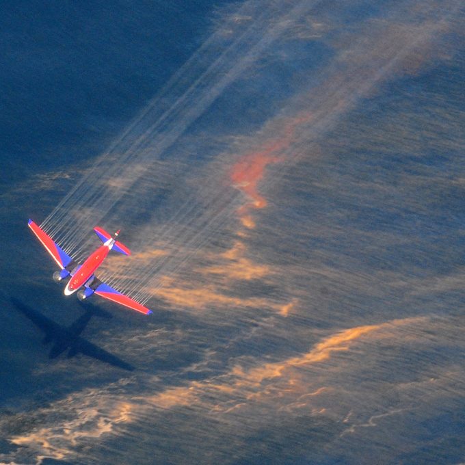 The crew of a Basler BT-67 fixed wing aircraft release oil dispersant over an oil spill from the mobile offshore drilling unit, Deepwater Horizon, off the shore of Louisiana, May 5, 2010. (U.S. Coast Guard photo by Petty Officer 3rd Class Stephen Lehmann)