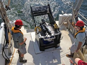 USM graduate student John Ransom (left) and postdoctoral researcher Dr. Jesse Filbrun (right) prepare to deploy the multinet sampler during a cruise off the coast of Alabama in July 2013. (Credit: USM Fisheries Oceanography and Ecology Lab)