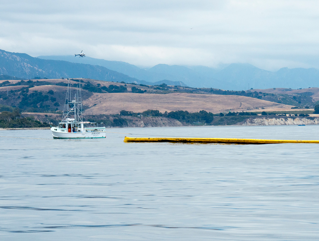 Crews clean-up the oil using boom operations off the coast of Goleta, Calif., May 21, 2015. The clean-up operation for the spill began the evening of Tuesday May 19, 2015. (U.S. Coast Guard photo by Petty Officer 3rd Class Andrea Anderson)