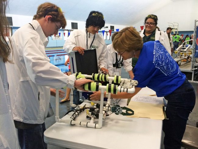 Dr. Tina Miller-Way conducts a safety inspection on Jinks Middle School’s ROV prior to competition. (Photo credit: Tracy Ippolito)