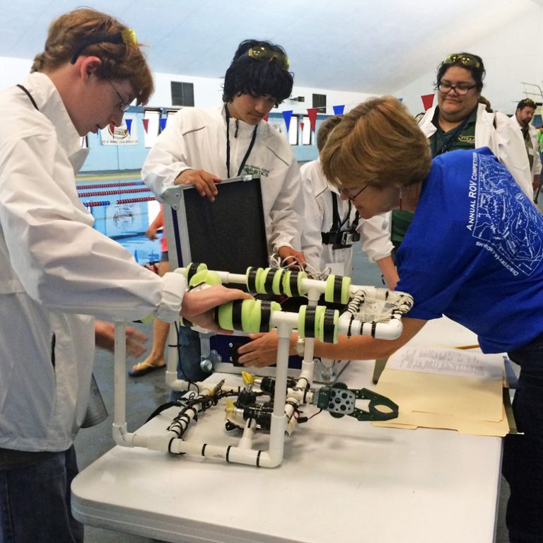 Dr. Tina Miller-Way conducts a safety inspection on Jinks Middle School’s ROV prior to competition. (Photo credit: Tracy Ippolito)